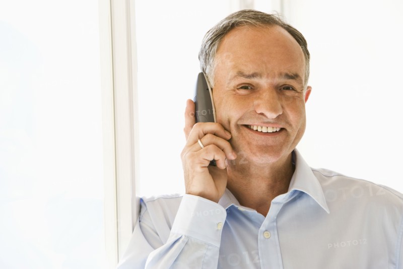 Businessman talking on phone in office