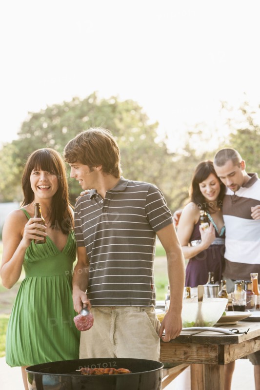 Friends having barbecue outdoors