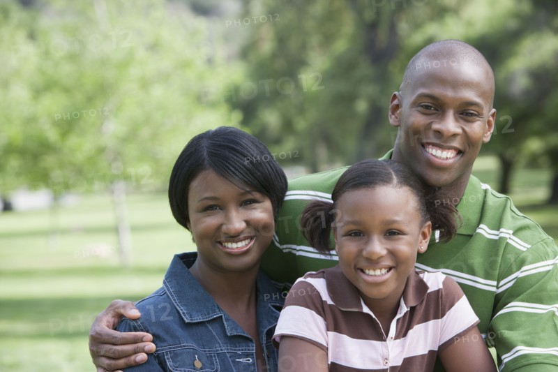 Family smiling together in park