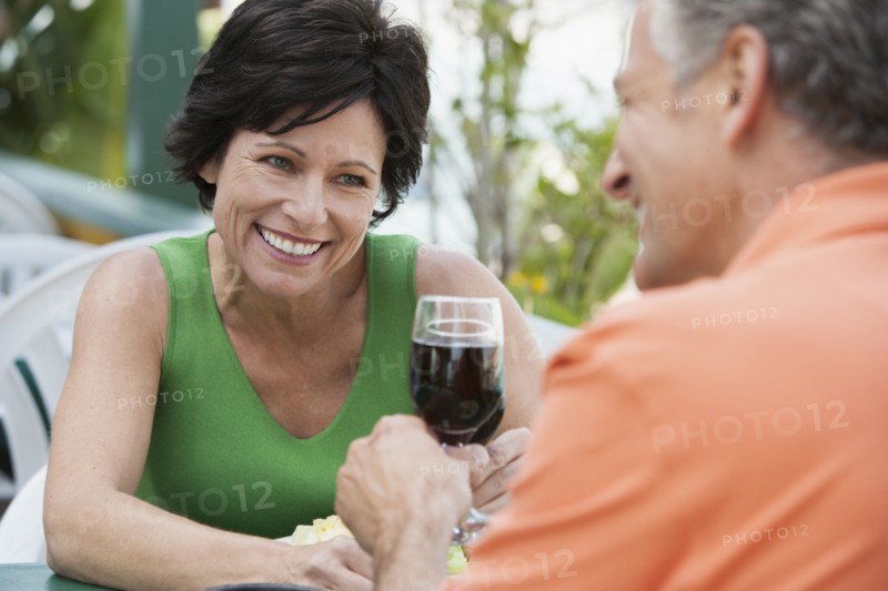 Caucasian couple toasting each other with wine