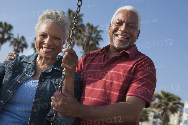 Senior African American couple on swing set