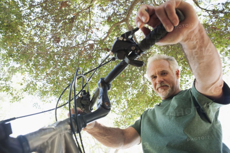 Senior Caucasian man riding bicycle outdoors