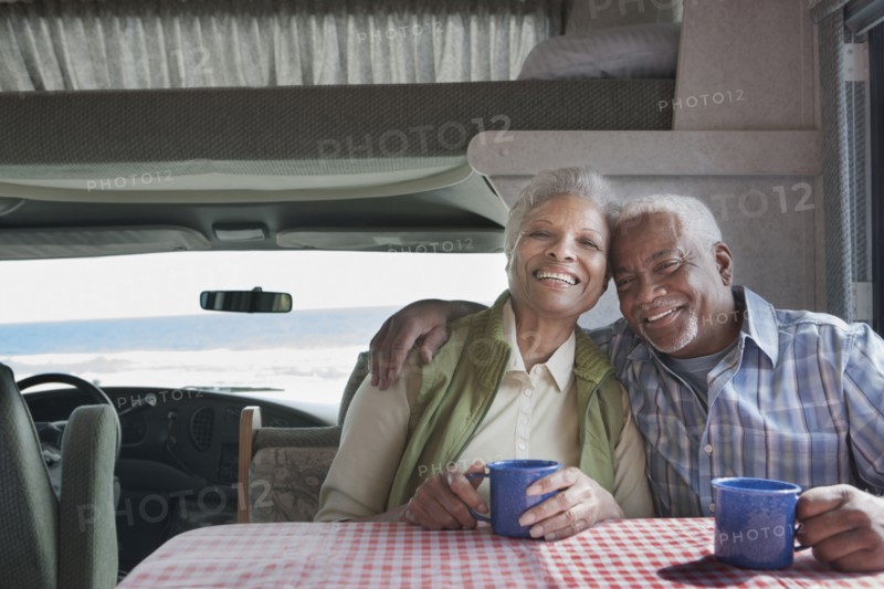 Mixed race Senior couple having coffee in RV
