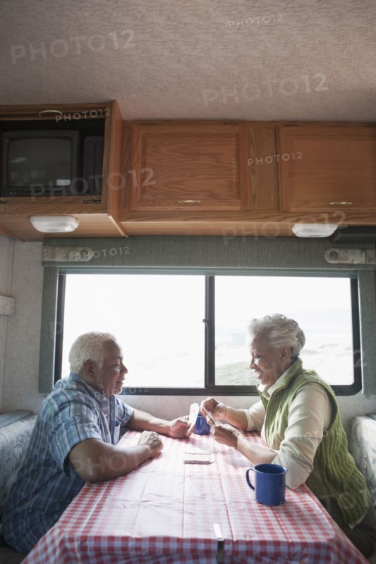Mixed race Senior couple having coffee in RV