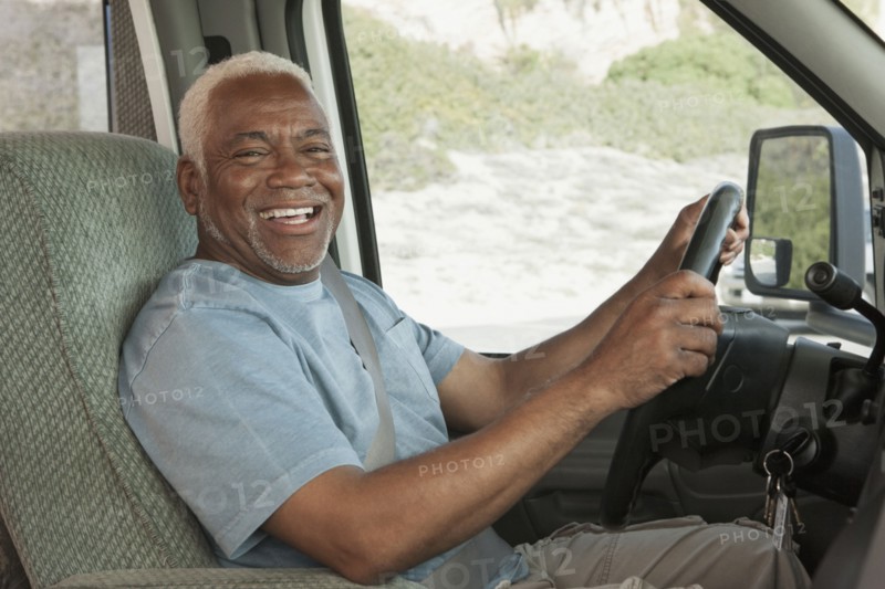 Mixed race Senior man driving RV