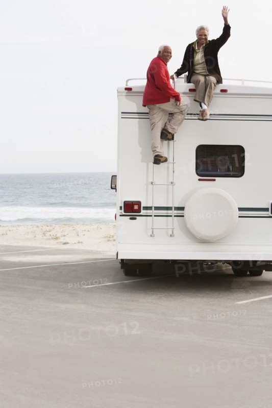 Mixed race Senior couple sitting on RV