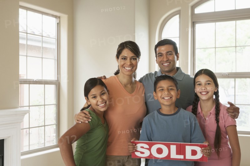 Hispanic family smiling in new home