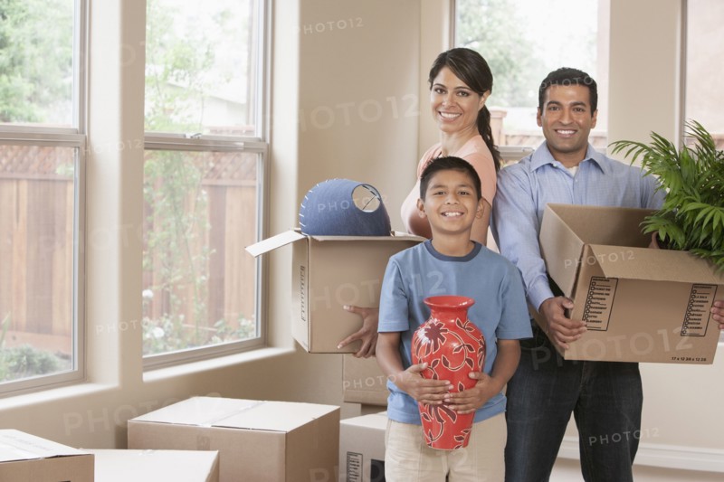 Hispanic family unpacking in new home