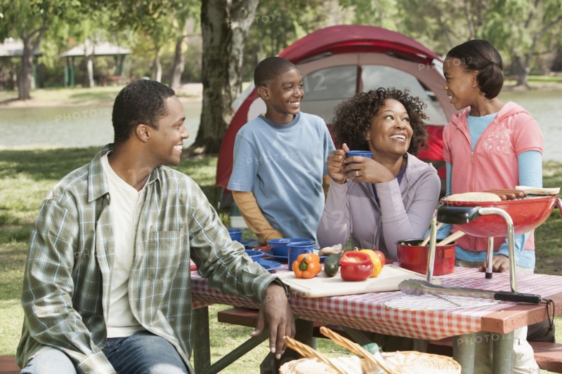 Family cooking together at campsite