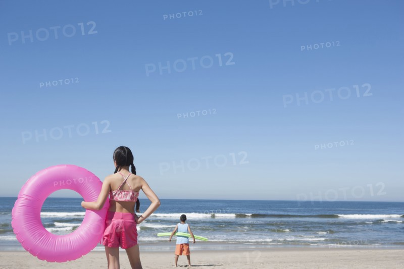 Hispanic children playing on beach