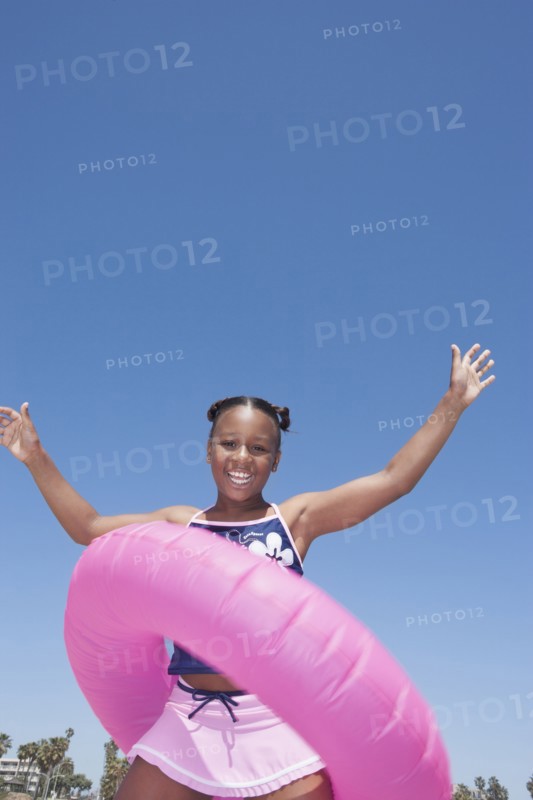 African American girl playing with inner tube