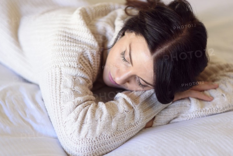 Caucasian woman napping on bed