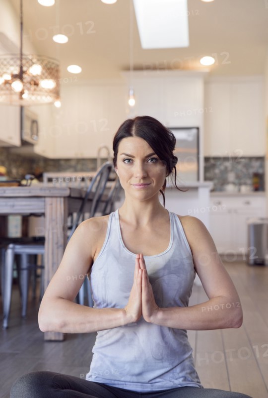 Caucasian woman performing yoga and meditating