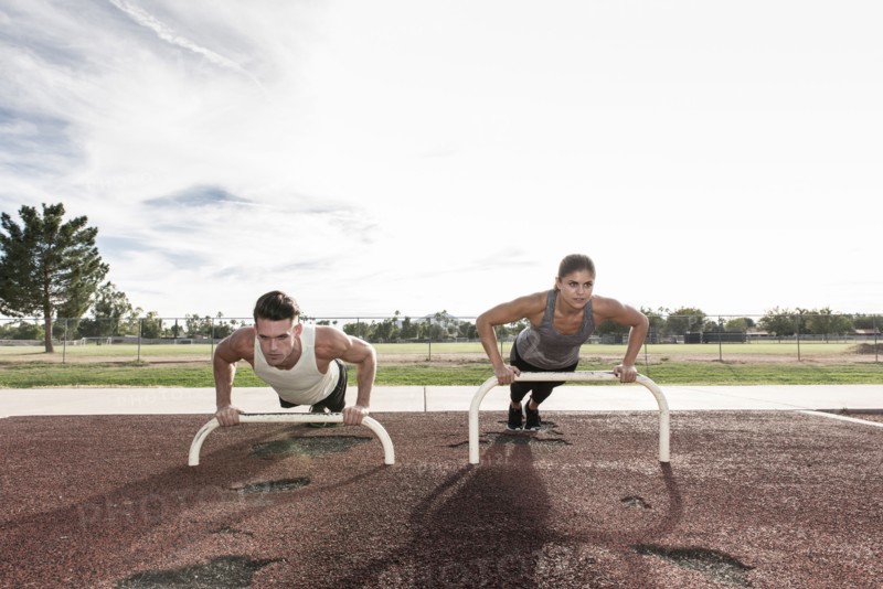 Couple doing push-ups outdoors
