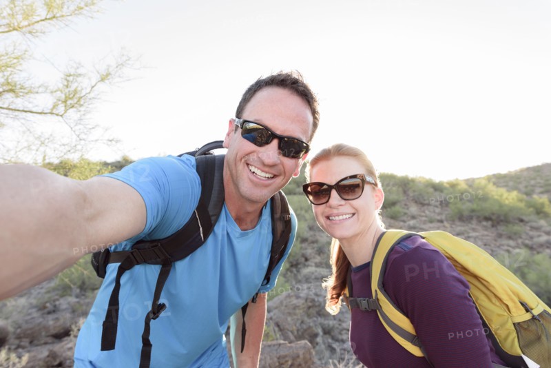 Hikers posing for cell phone selfie