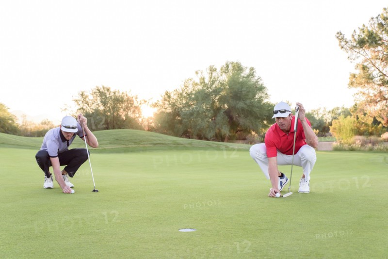 Golfers aiming on golf course