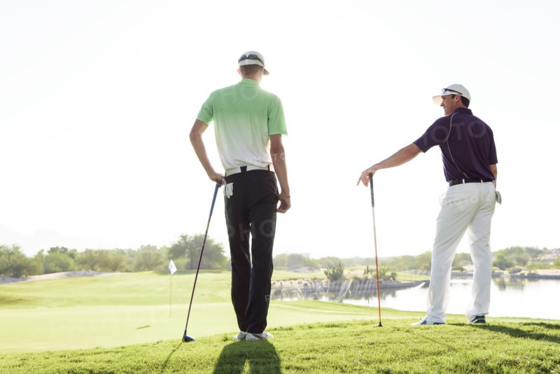 Friends talking on golf course