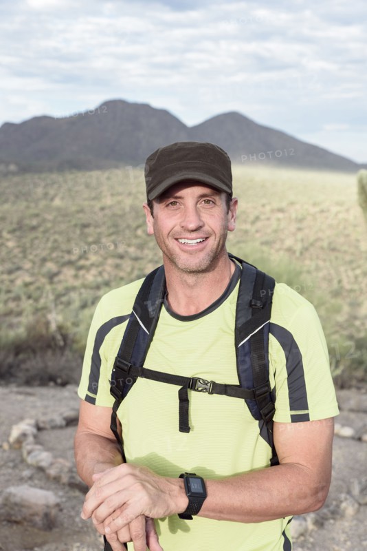 Portrait of smiling Hispanic man hiking in desert