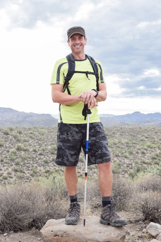 Portrait of smiling Hispanic man hiking in desert
