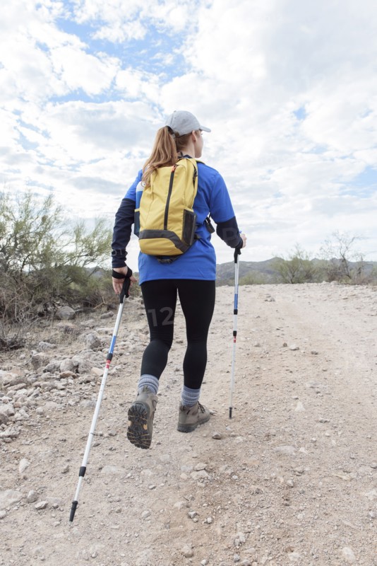 Caucasian woman hiking on rocky path in desert