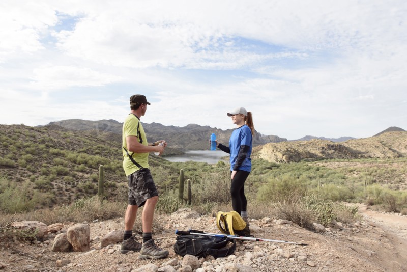 Couple resting while hiking in desert