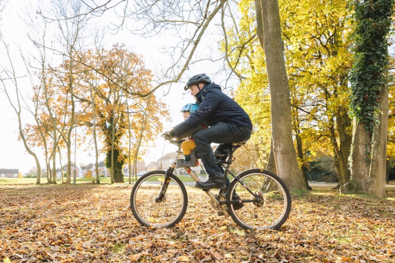 Caucasian father and son riding bicycle