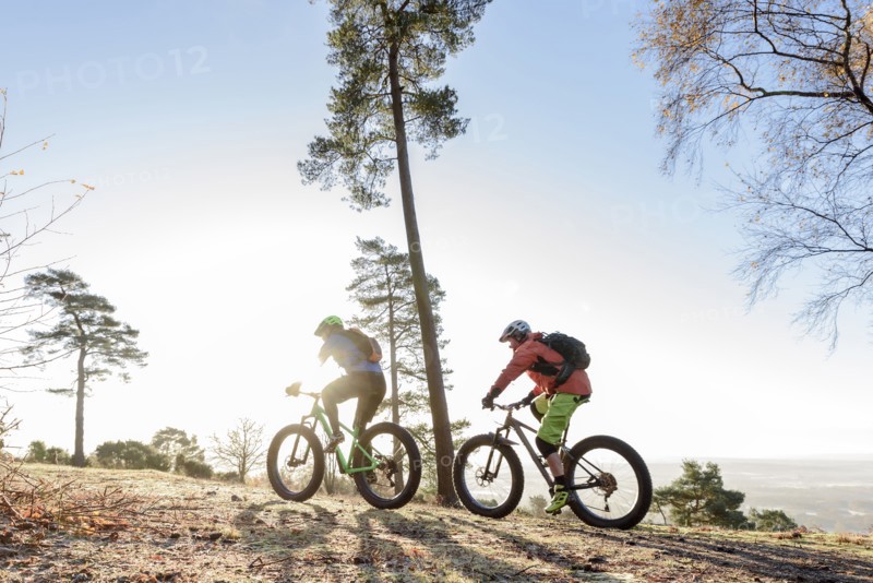 Caucasian couple riding bicycles