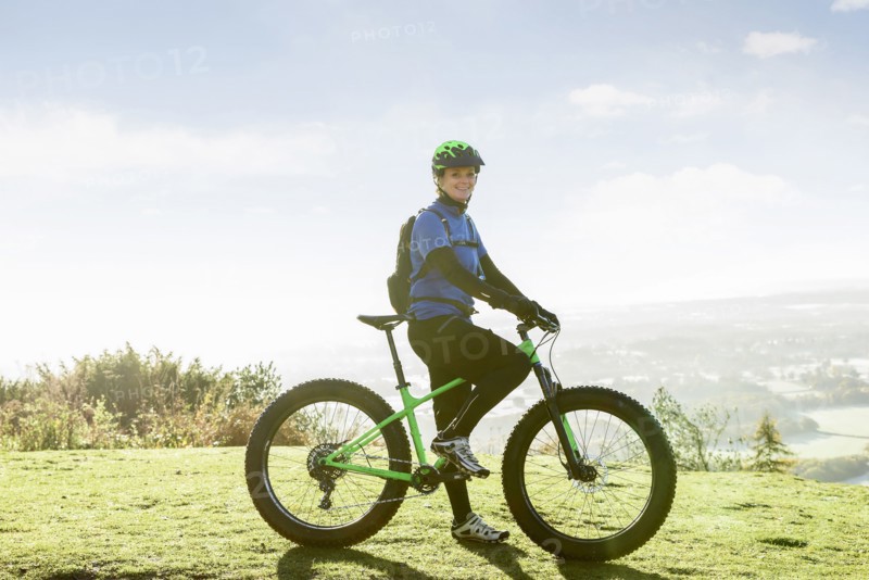 Portrait of smiling Caucasian woman riding bicycle