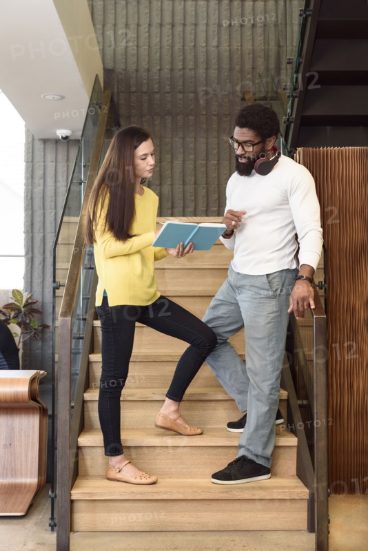 Creative business people talking on staircase