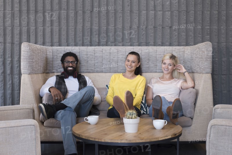 Portrait of smiling friends in lounge