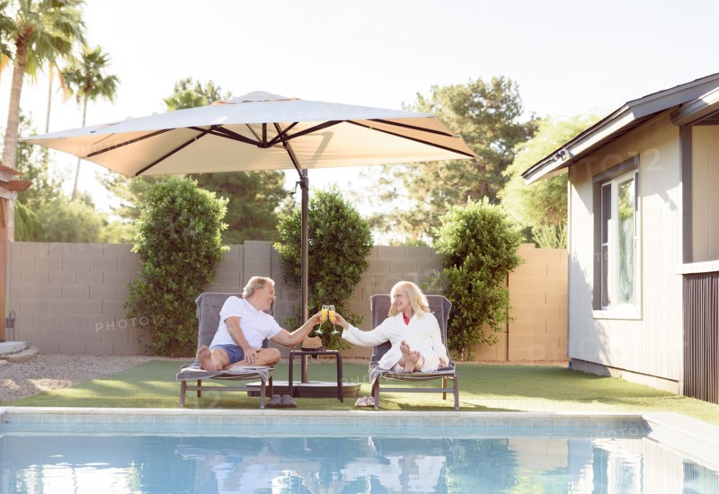 Caucasian couple toasting near swimming pool