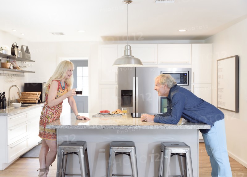 Caucasian couple talking in the kitchen