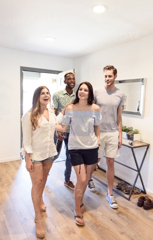 Smiling couples walking indoors