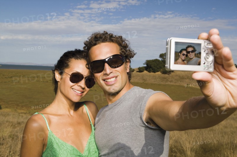 Couple taking self-portrait with camera