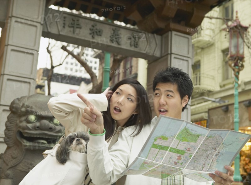 Young Asian couple looking at a map