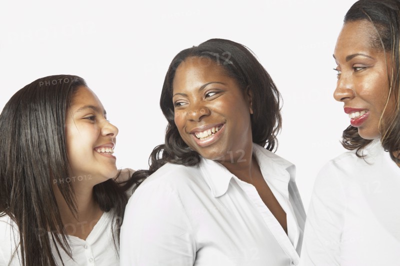 Studio shot of African mother and daughters smiling