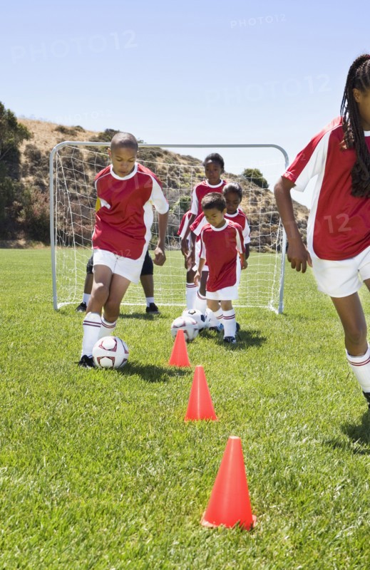 Multi-ethnic children playing soccer