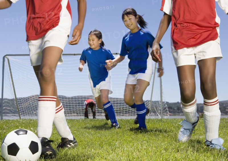 Multi-ethnic children playing soccer
