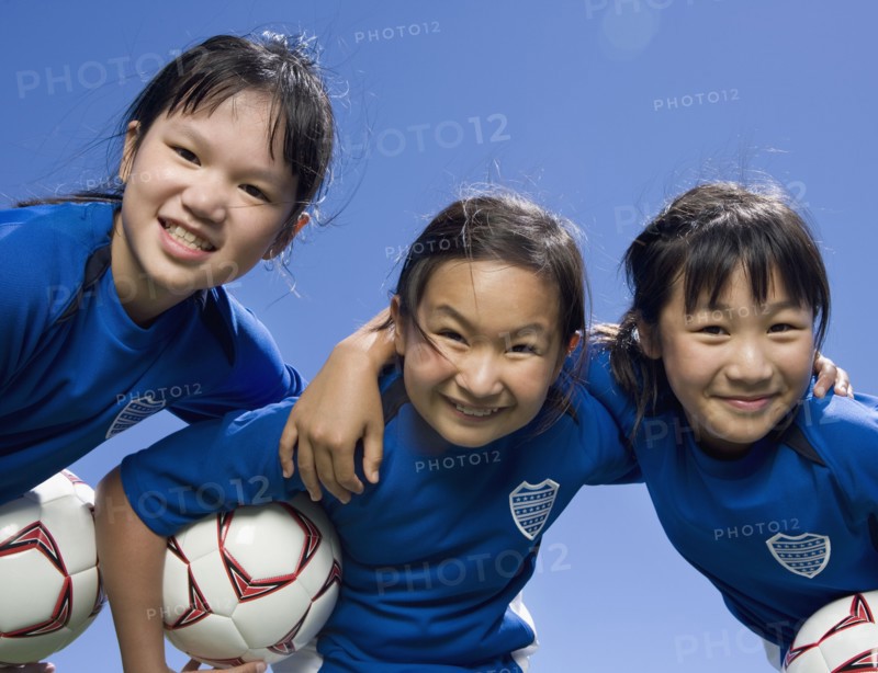 Multi-ethnic girls with soccer ball