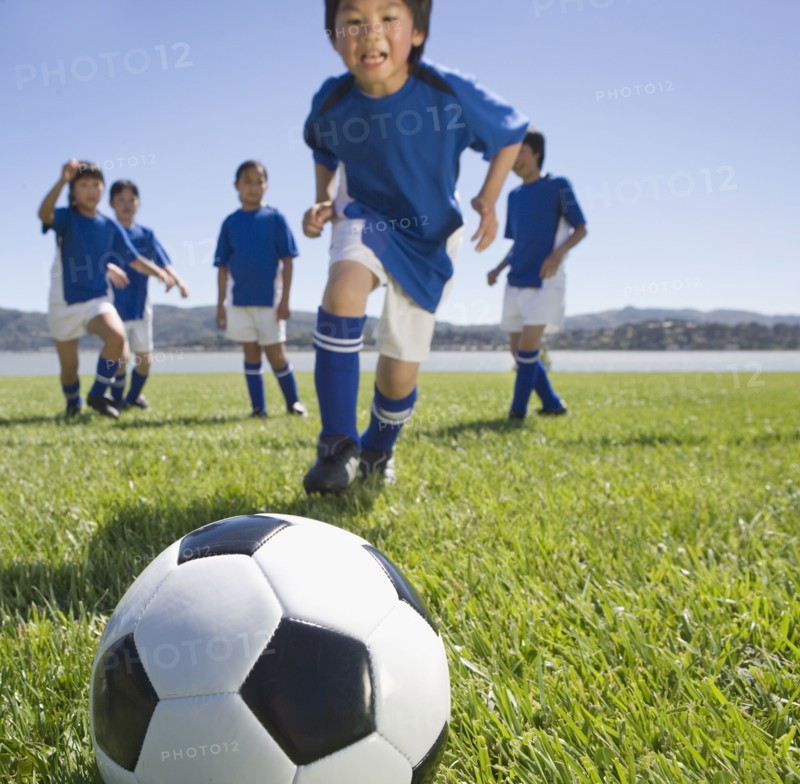 Multi-ethnic children playing soccer