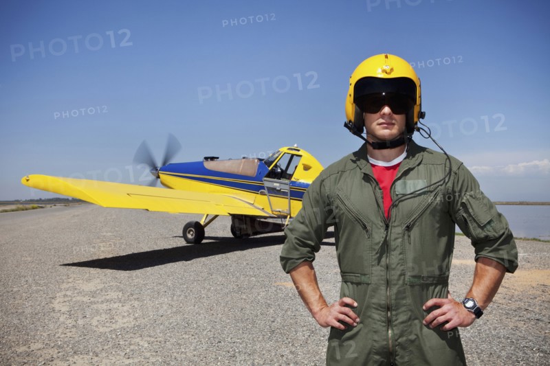 Pilot standing near small airplane