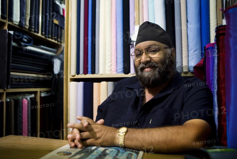 Indian business owner sitting in fabric store