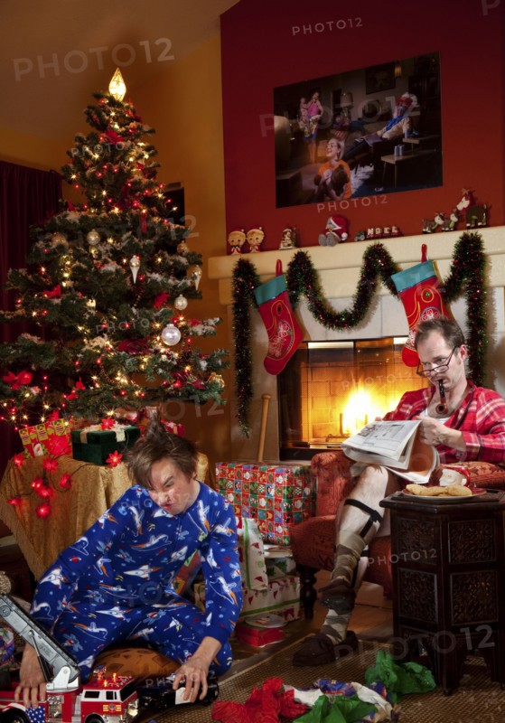 Caucasian father and son in living room on Christmas morning