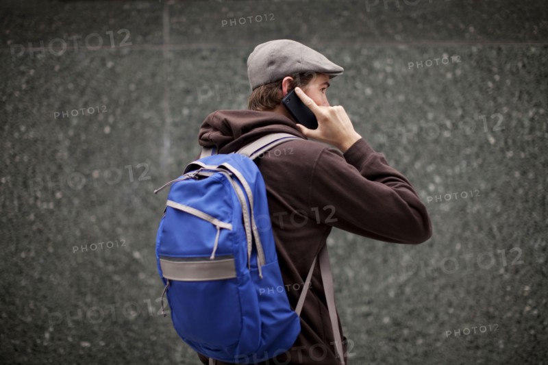 Caucasian man in backpack talking on cell phone