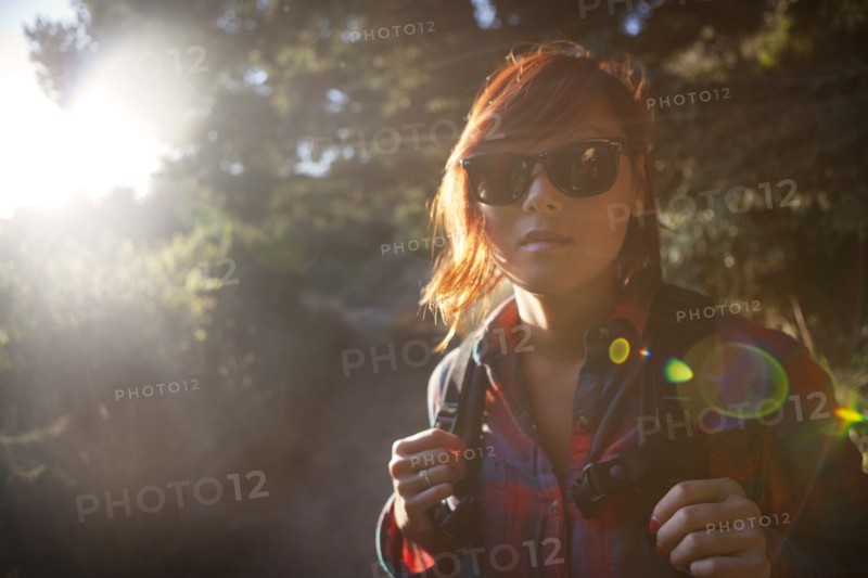 Korean woman in backpack and sunglasses