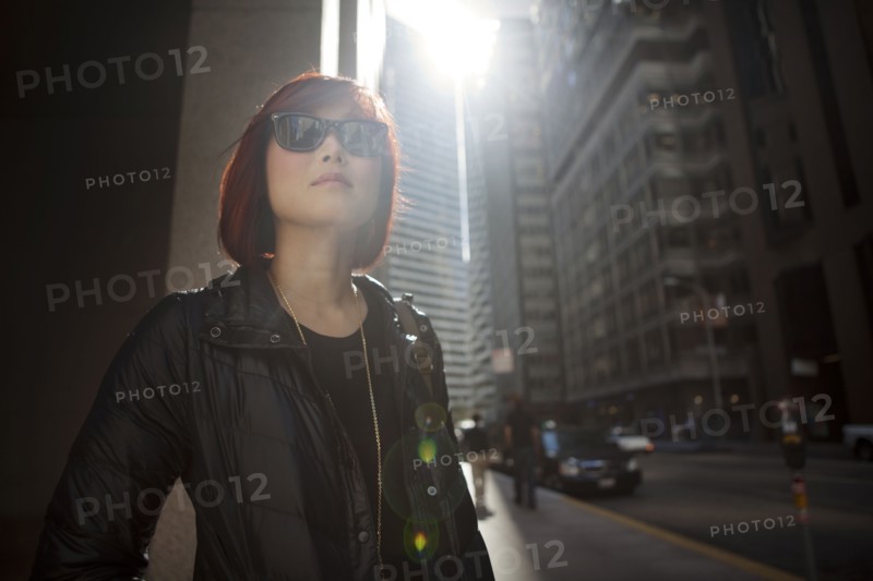 Korean woman walking on city sidewalk