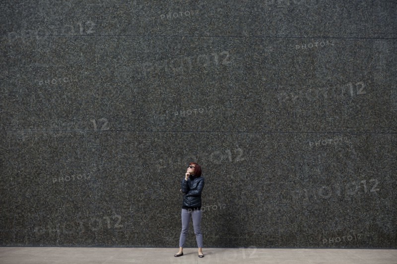 Korean woman standing in city sidewalk
