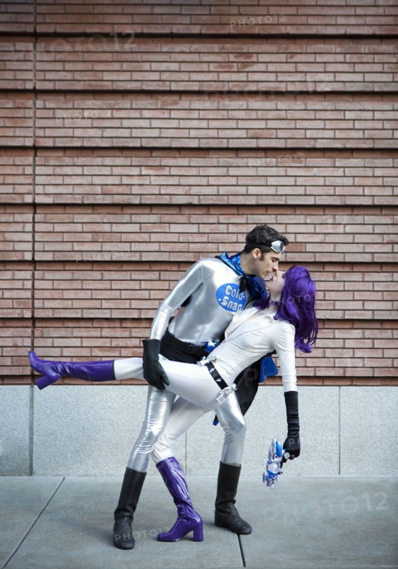 Couple in superhero costumes kissing