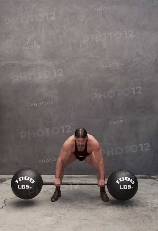 Caucasian weight lifter straining