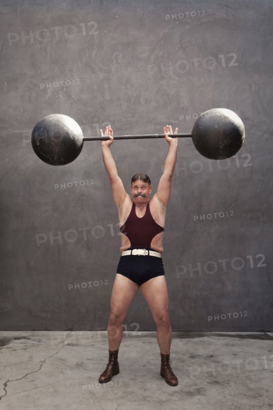 Caucasian weight lifter straining